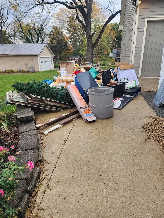 Dumpster being loaded with debris for Commercial Dumpster Rental in Reidsville